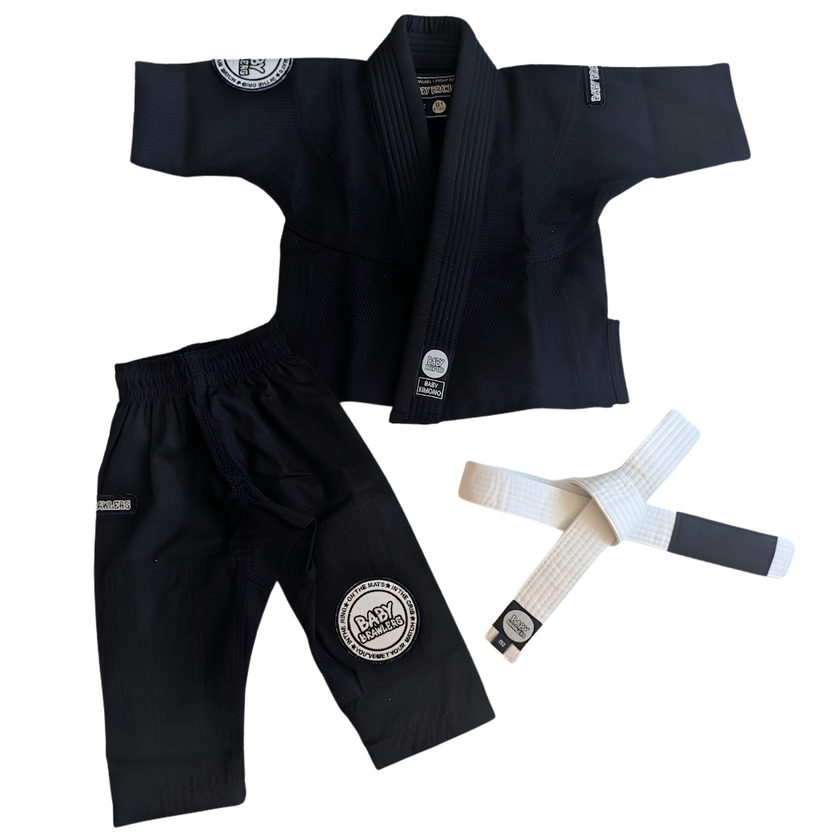 A black Brazilian Jiu-Jitsu gi set laid out on a white background, including a gi jacket, matching gi shorts, and a white belt with black end bands. The gi has circular patches on the shoulder and leg.