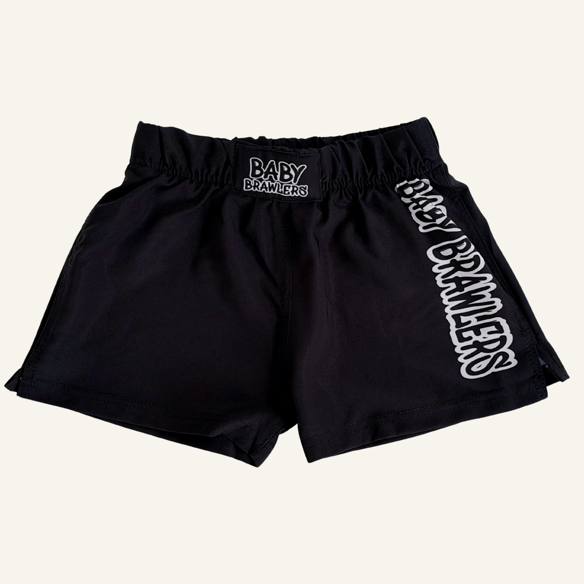 Black athletic shorts with a satin-like finish, featuring an elastic waistband with a central 'BABY BRAWLERS' patch and large vertical 'BABY BRAWLERS' text outlined in white on the left leg.