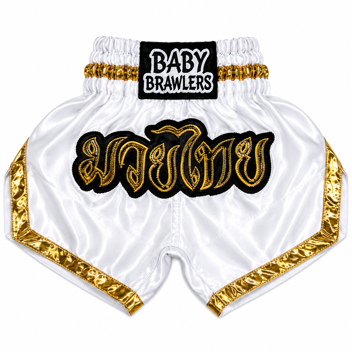 White satin Muay Thai shorts with gold trim, featuring a black and gold 'BABY BRAWLERS' brand patch on the waistband and a large gold and black embroidered Thai script across the front.