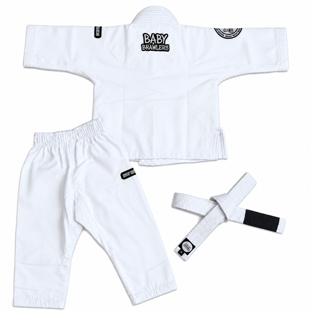 White Brazilian Jiu-Jitsu gi set for babies, including a short-sleeve top, matching pants, and a white belt with a black tab, laid out on a white background.