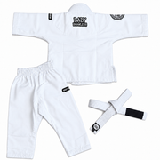 White Brazilian Jiu-Jitsu gi set for babies, including a short-sleeve top, matching pants, and a white belt with a black tab, laid out on a white background.